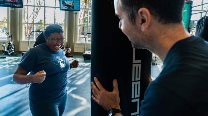 Dr. Ray Pastore And A Student Work On Strengthening Abdominal Muscles And Improving Eye-hand Coordination With A Boxing Heavy Bag At The UNCW Student Recreation Center In Wilmington, NC.| Professional Gamer